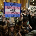 Protesters fill the Iowa state Capitol to denounce a bill that would strip the state civil rights code of protections based on gender identity, Thursday, Feb. 27, 2025, in Des Moines, Iowa. (AP Photo/Charlie Neibergall)